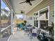 Relaxing screened porch with seating area and ceiling fan at 3206 Safe Harbor Way, Charleston, SC 29414