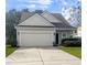 Gray siding house with a two-car garage and landscaped lawn at 3313 Pavilion Lake Dr, Johns Island, SC 29455