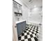 Updated bathroom with gray vanity, checkered floor, and white bathtub at 348 Cleveland St, Walterboro, SC 29488