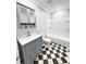 Updated bathroom with gray vanity, checkered floor, and white bathtub at 348 Cleveland St, Walterboro, SC 29488