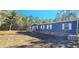 Blue single-story home with deck and wooded lot at 355 Dike Rd Rd, Bonneau, SC 29431