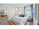 Bright bedroom with white bedding, blue accents, and a charming window at 358 Trailmore Ln, Summerville, SC 29486