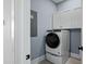 Bright laundry room with washer, dryer, and white cabinets at 358 Trailmore Ln, Summerville, SC 29486