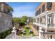 Charming brick courtyard with lush landscaping and seating area at 38 Hasell St, Charleston, SC 29401