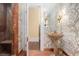 Charming bathroom with patterned wallpaper and a pedestal sink at 38 Hasell St, Charleston, SC 29401