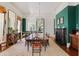 Bright dining room with a long table and fireplace at 38 Hasell St, Charleston, SC 29401