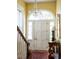 Elegant entry with chandelier, hardwood floors, and white door at 38 Hasell St, Charleston, SC 29401