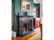 Dark marble fireplace with brass accents, adds warmth and charm at 38 Hasell St, Charleston, SC 29401