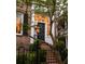 Elegant front entrance with gas lamps and brick facade at 38 Hasell St, Charleston, SC 29401