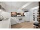 Bright kitchen with white cabinets, exposed brick, and modern appliances at 38 Hasell St, Charleston, SC 29401