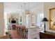 Open kitchen with granite island, white cabinetry, and hardwood floors at 38 Hasell St, Charleston, SC 29401