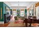 Green living room with hardwood floors, fireplace, and antique furniture at 38 Hasell St, Charleston, SC 29401