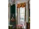 Living room with large window, ornate window treatments, and antique furniture at 38 Hasell St, Charleston, SC 29401