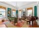 Spacious living room with green walls, piano, and antique furniture at 38 Hasell St, Charleston, SC 29401