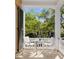 Charming porch with white chairs and a glass-top table at 38 Hasell St, Charleston, SC 29401