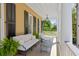 Spacious porch with white sofa and lush greenery at 38 Hasell St, Charleston, SC 29401