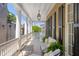 Serene porch with white furniture and city views at 38 Hasell St, Charleston, SC 29401