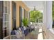 Relaxing porch with wicker furniture and white columns at 38 Hasell St, Charleston, SC 29401