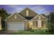 Two-story house with neutral siding, white garage door, and landscaping at 382 Willows Crescent Dr, Moncks Corner, SC 29461