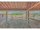 View from inside a barn stall towards pasture at 3980 River Rd, Johns Island, SC 29455