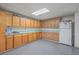 Basement workshop area with cabinets and refrigerator at 3980 River Rd, Johns Island, SC 29455