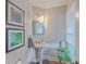 Stylish bathroom with pedestal sink and window at 3980 River Rd, Johns Island, SC 29455