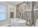 Bathroom with soaking tub and modern tile work at 3980 River Rd, Johns Island, SC 29455