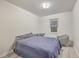 Comfortable bedroom with a queen bed, window, and a sitting chair at 3980 River Rd, Johns Island, SC 29455