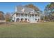 Two story home with wrap around porch and spacious yard at 3980 River Rd, Johns Island, SC 29455
