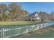 House exterior showcasing large backyard and white fence at 3980 River Rd, Johns Island, SC 29455