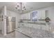 Modern kitchen with white cabinets, granite countertops, and stainless steel appliances at 3980 River Rd, Johns Island, SC 29455