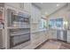Modern kitchen with stainless steel appliances and white cabinetry at 3980 River Rd, Johns Island, SC 29455