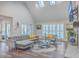 Open living room with gray sectional sofa and large windows at 3980 River Rd, Johns Island, SC 29455