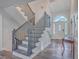 Elegant staircase with dark wood railing and white risers at 3980 River Rd, Johns Island, SC 29455