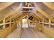 Unfinished attic with wooden beams and flooring at 455 Switchgrass Dr, Summerville, SC 29486