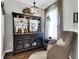 Cozy bar area with a charming built-in cabinet and comfortable armchair at 455 Switchgrass Dr, Summerville, SC 29486