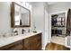 Bathroom with vanity, large mirror, and walk-in closet at 455 Switchgrass Dr, Summerville, SC 29486