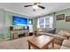 Bonus room with large TV, sofas, and media console at 455 Switchgrass Dr, Summerville, SC 29486
