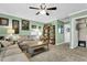 Bonus room with sofas, coffee table, built-in shelves, and ceiling fan at 455 Switchgrass Dr, Summerville, SC 29486