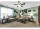 Spacious bonus room with two sofas, coffee table, and decorative wall art at 455 Switchgrass Dr, Summerville, SC 29486