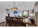Bright dining area with wood table and chairs, adjacent to living room at 455 Switchgrass Dr, Summerville, SC 29486