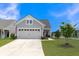 Gray house with a two-car garage and landscaped lawn at 455 Switchgrass Dr, Summerville, SC 29486