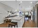 Modern kitchen with a large island, white cabinets, and stainless steel appliances at 455 Switchgrass Dr, Summerville, SC 29486