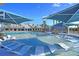 Expansive pool area with in-water loungers and shade structures at 455 Switchgrass Dr, Summerville, SC 29486