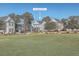House nestled in a neighborhood with green space at 459 Spring Hollow Dr, Charleston, SC 29492