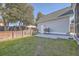 Landscaped backyard with patio, grill, and wooden fence at 459 Spring Hollow Dr, Charleston, SC 29492