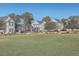 Expansive green space with views of charming neighborhood homes at 459 Spring Hollow Dr, Charleston, SC 29492