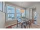 Bright dining area features a rustic wooden table and three metal chairs, complemented by large windows at 459 Spring Hollow Dr, Charleston, SC 29492