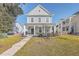 Two-story house with gray siding, front porch, and landscaped yard at 459 Spring Hollow Dr, Charleston, SC 29492