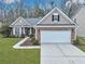 Brick front house with a two-car garage and well-manicured lawn at 469 Blue Dragonfly Dr, Charleston, SC 29414